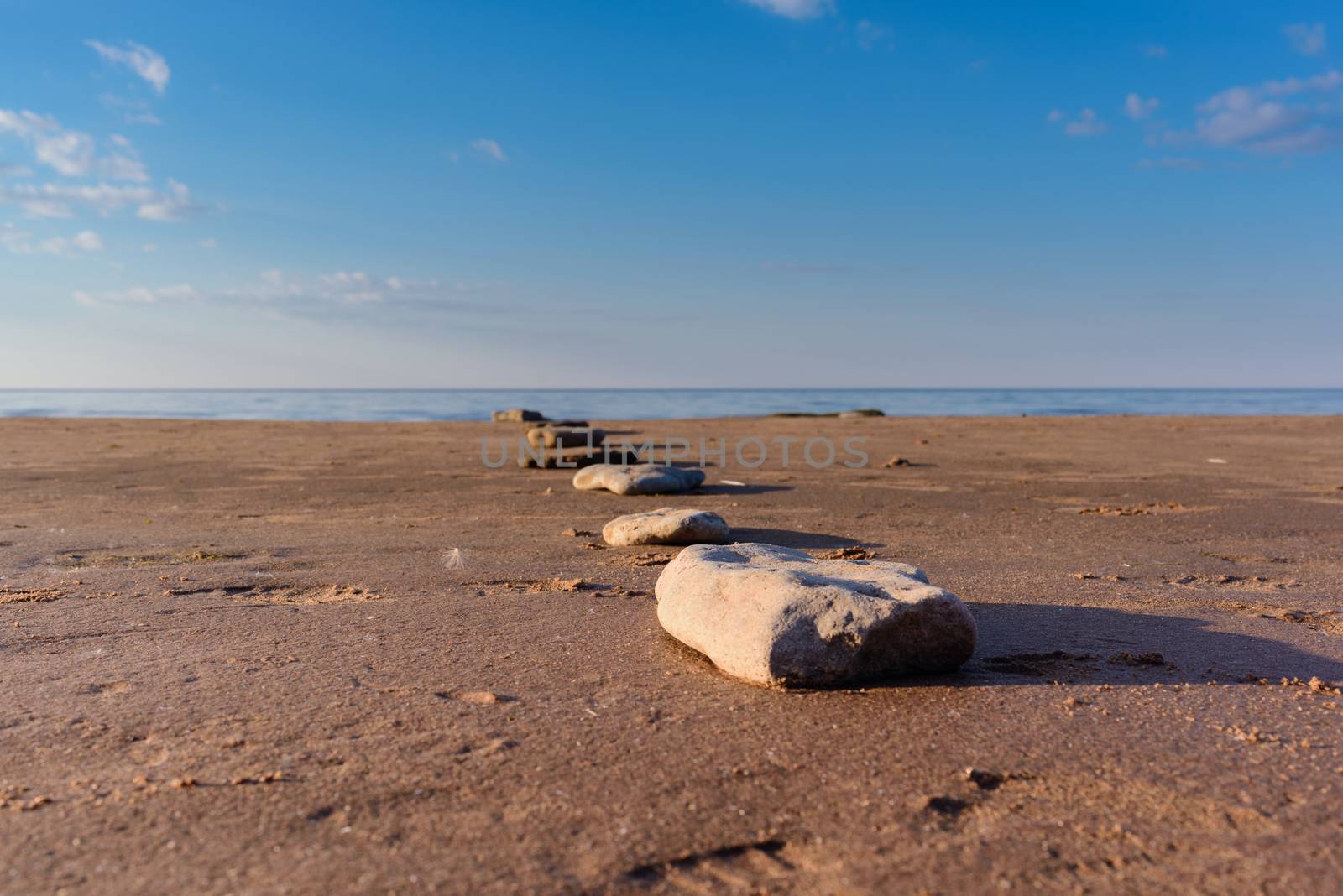 Stone footpath on the sandy beach