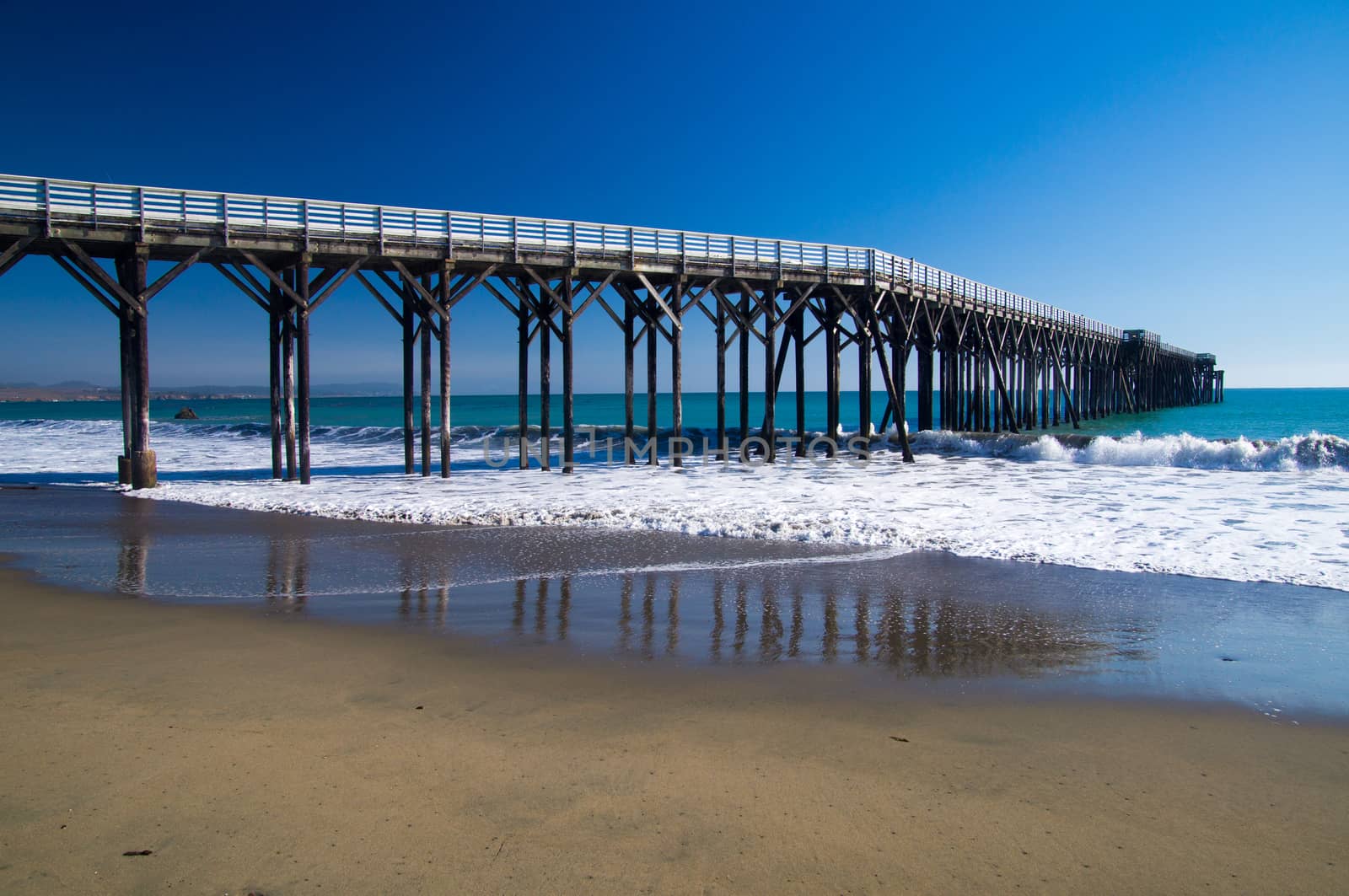 Pier winds into Pacific Ocean at California coast