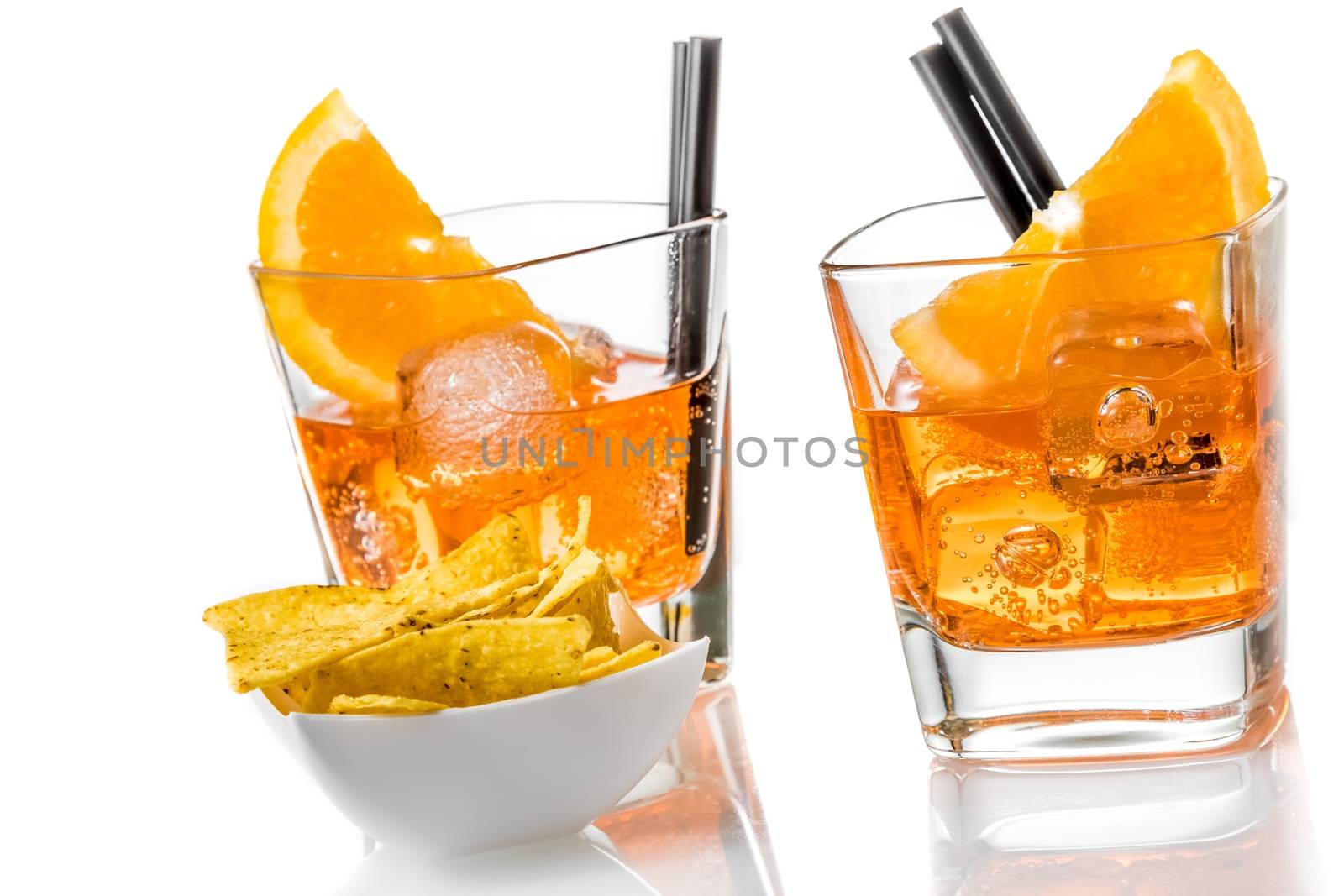 hot tacos chips in front of two glasses of spritz aperitif aperol cocktail with orange slices and ice cubes on white background