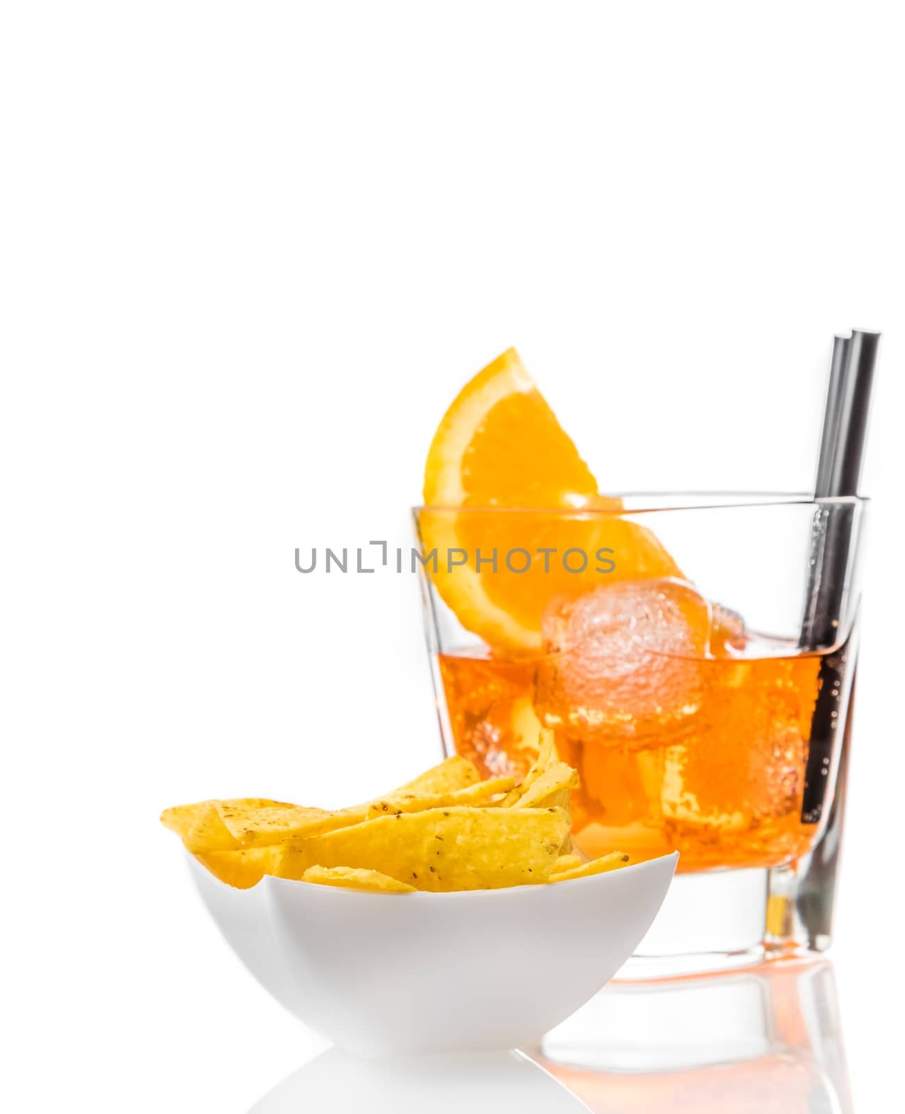 hot tacos chips in front of glass of spritz aperitif aperol cocktail with orange slices and ice cubes on white background