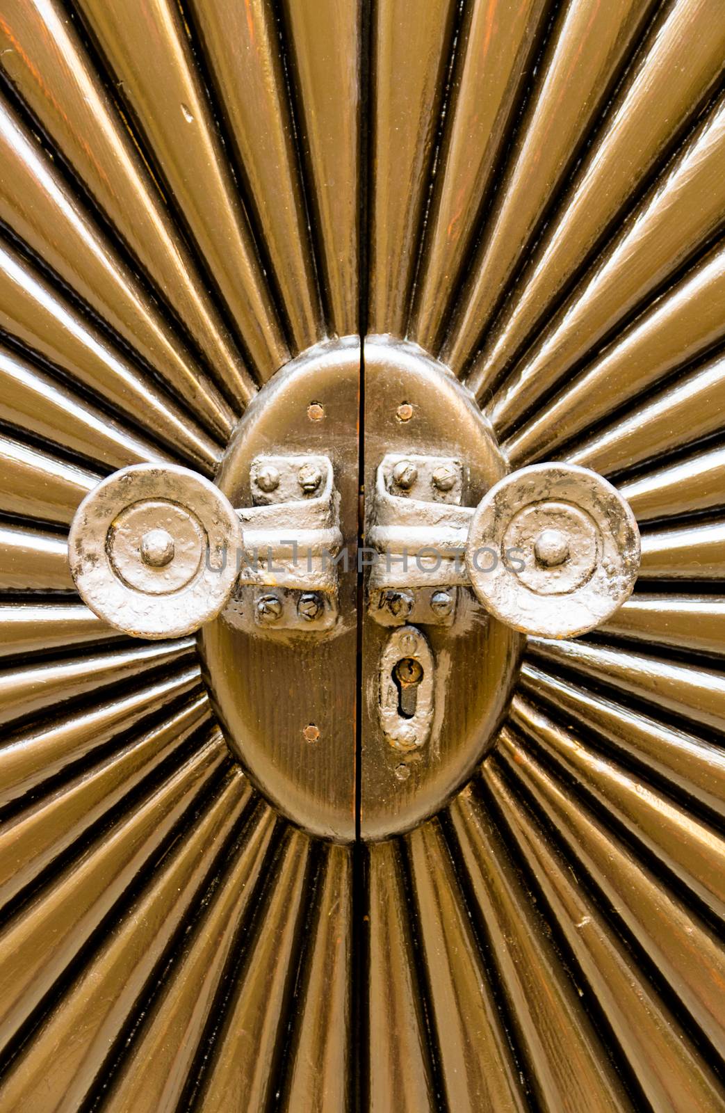 Metal door shaped sunburst with round handles.