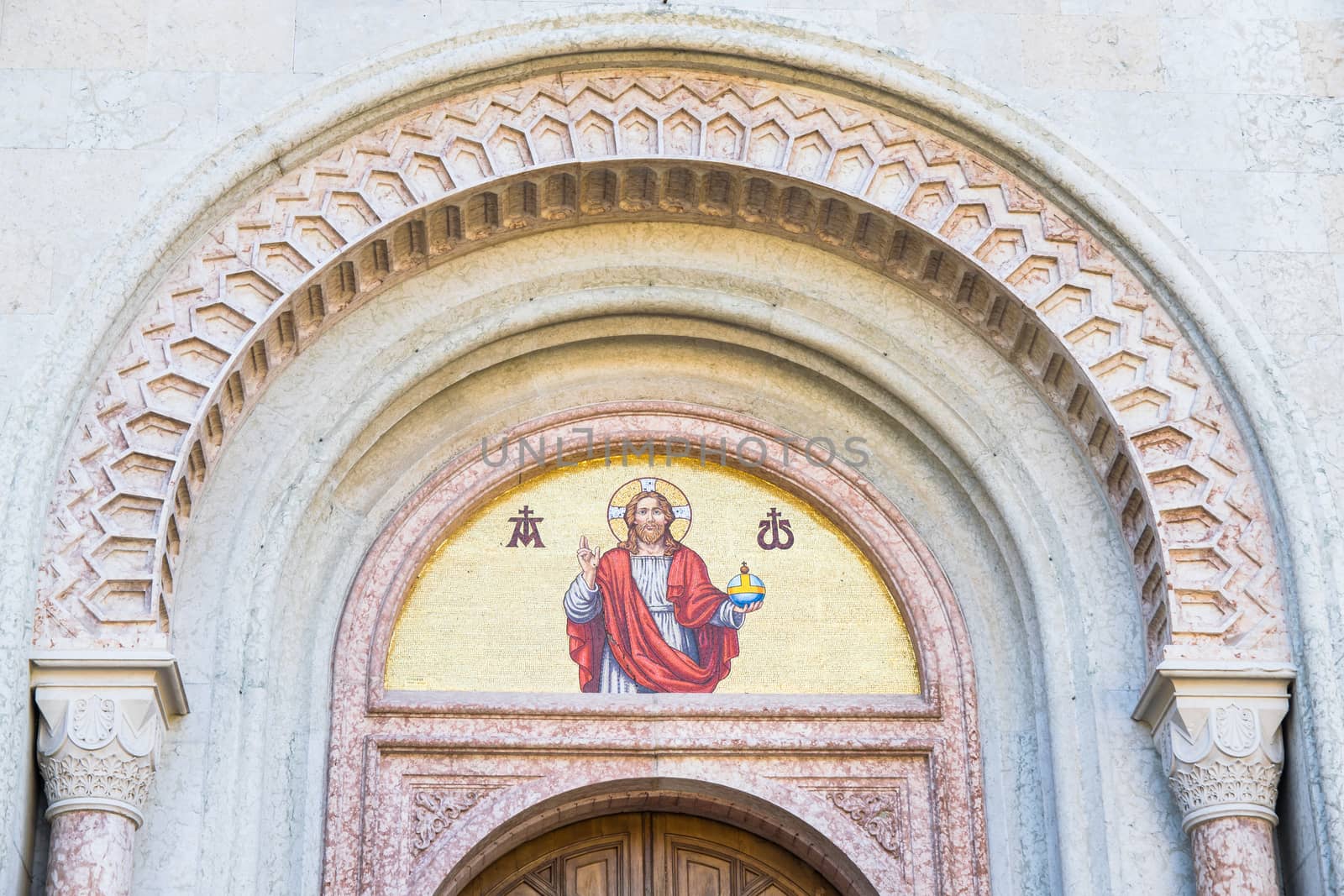 God's image mosaic above the doorway of an old church.