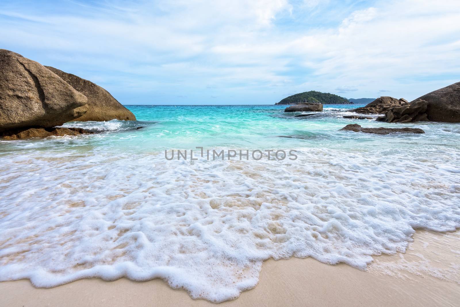 Beautiful nature of blue sea sand and white waves on small beach near the rocks during summer at Koh Miang island in Mu Ko Similan National Park, Phang Nga province, Thailand