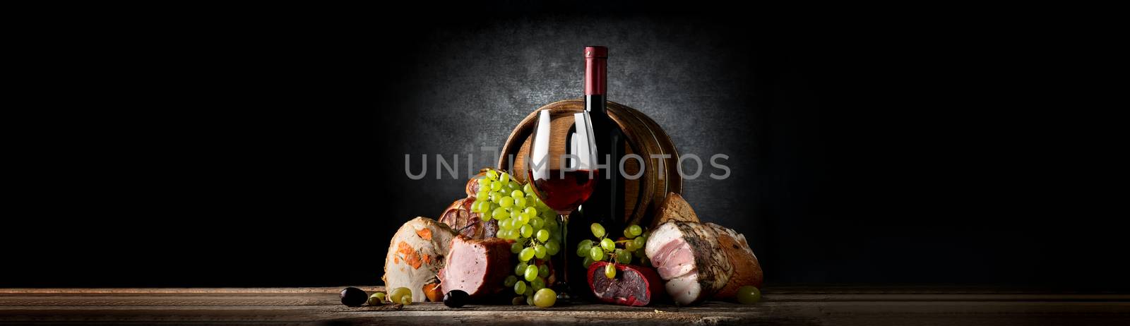 Composition with wine and food on a black background