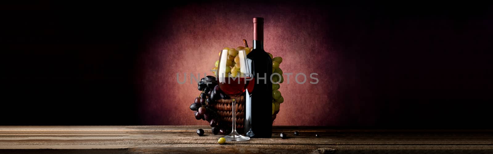 Wine with grape in basket on a vinous background