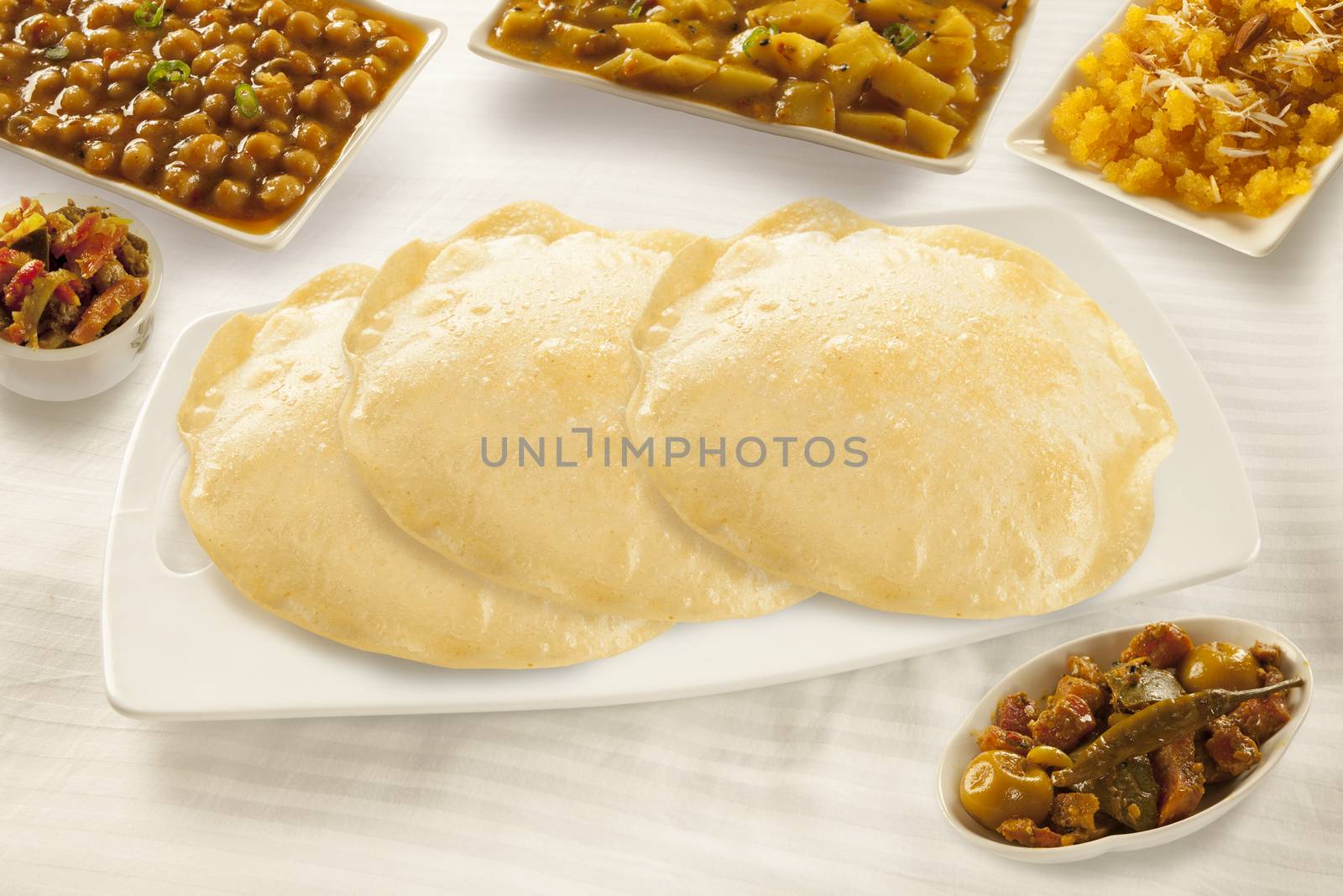 Puri paratha with chickpeas and sweet halwa and pickels 