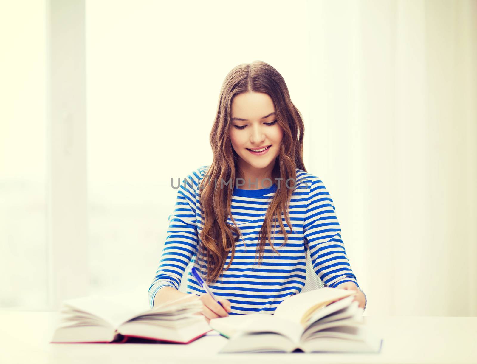 happy smiling student girl with books by dolgachov