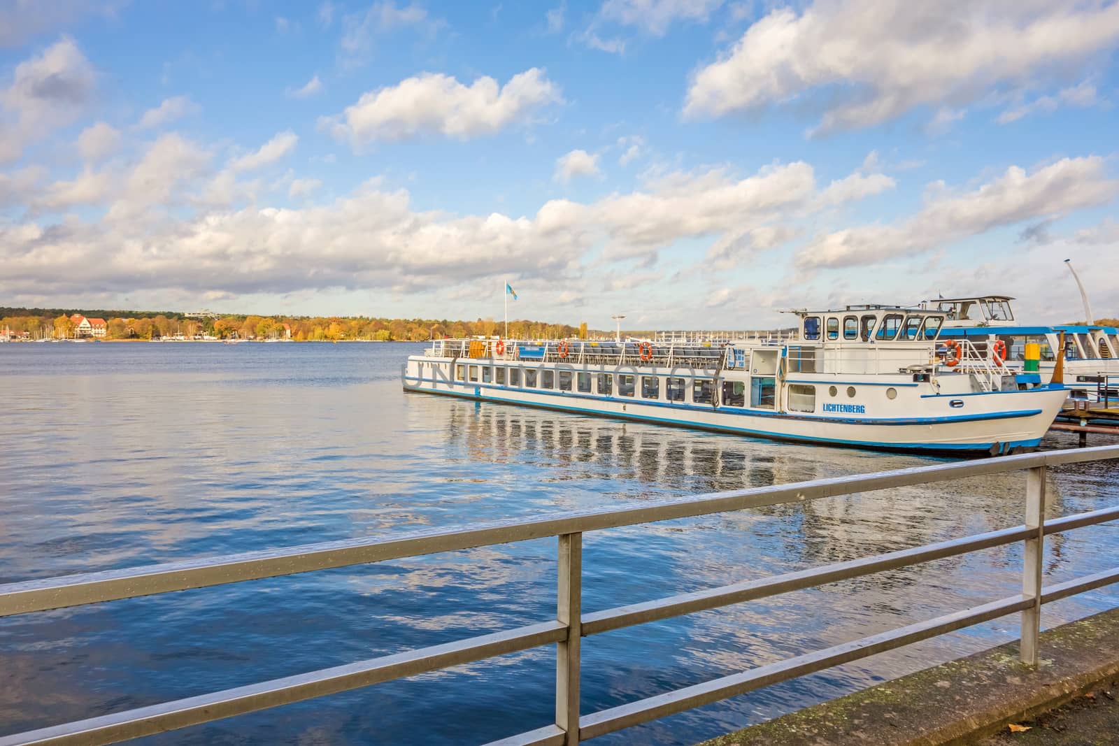 Berlin, Germany - October 27, 2013: View over the Lake Wannsee - the biggest in the hinterland of Berlin. Shipping pier with passenger ship on the right.