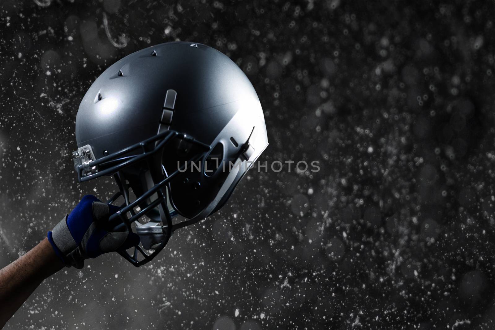 Composite image of cropped hand of sportsman holding helmet by Wavebreakmedia
