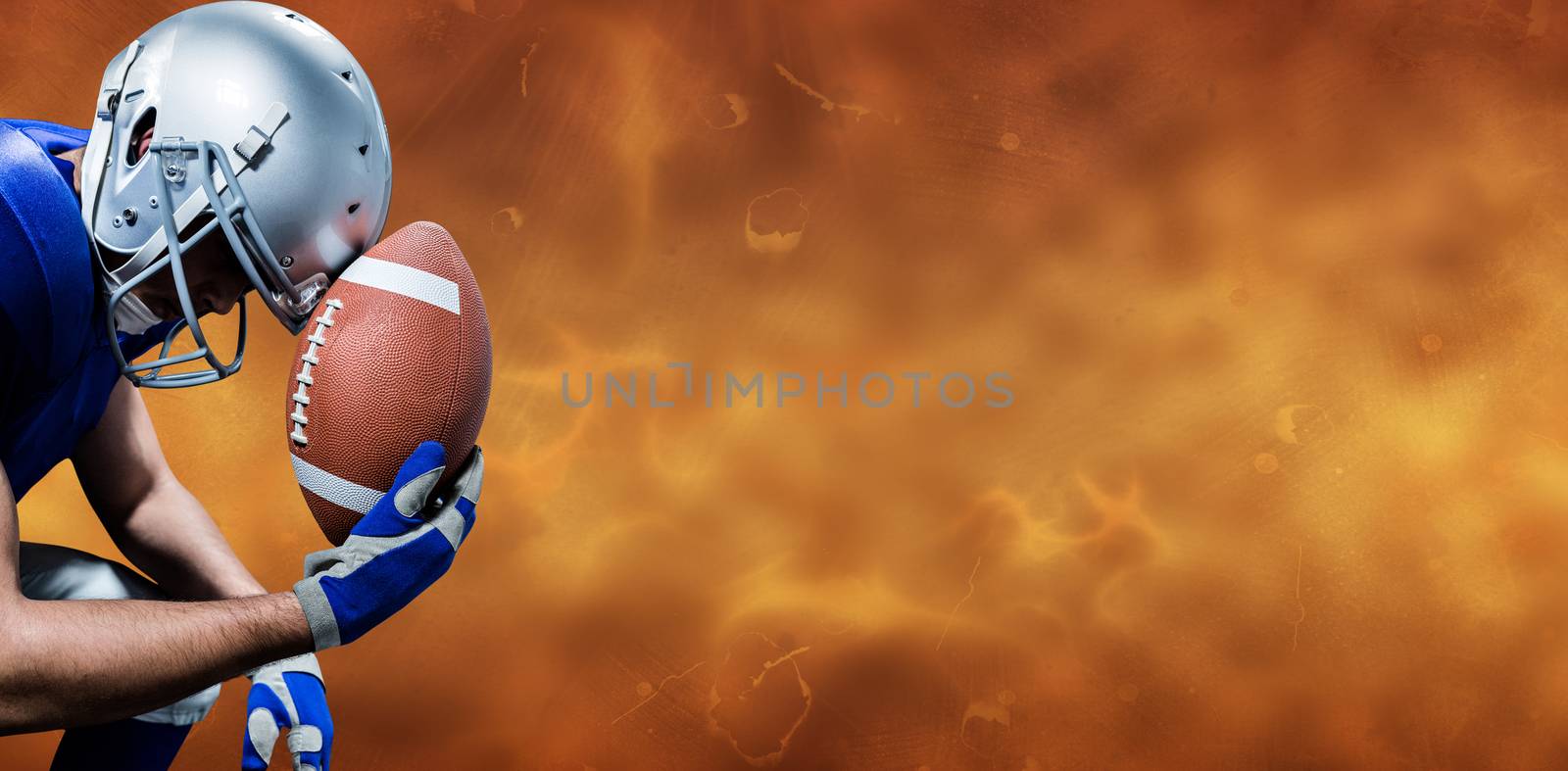 Close-up of upset American football player with ball against orange background