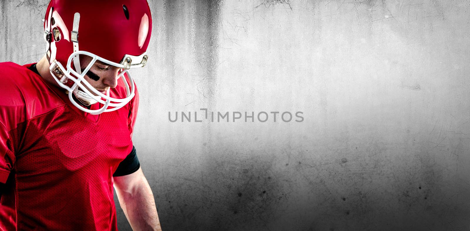 Composite image of close up view of american football player focusing by Wavebreakmedia