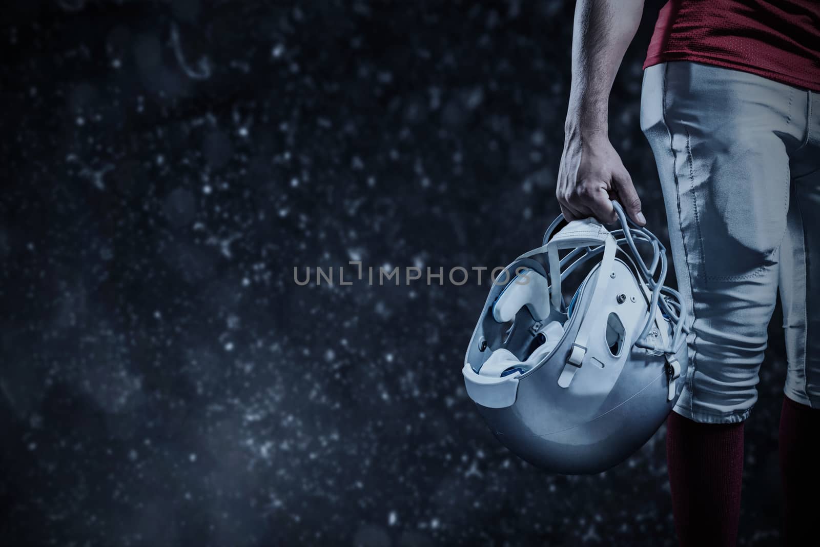 Composite image of cropped image of american football player holding helmet by Wavebreakmedia