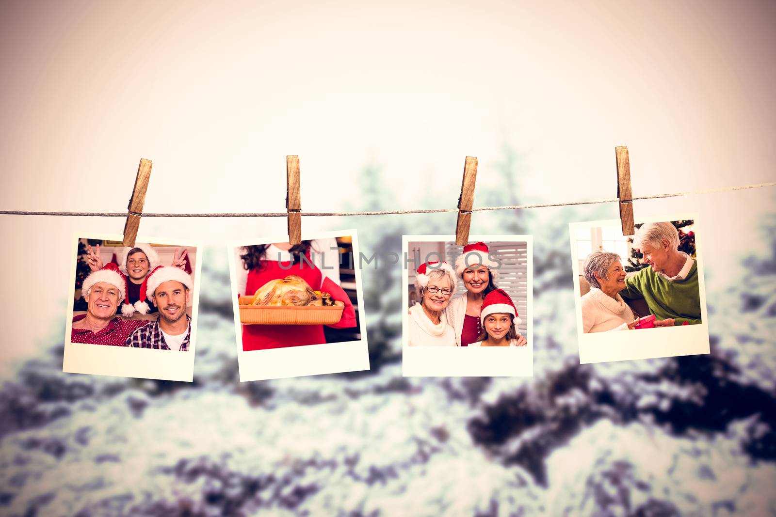 Clothes peg on line with instant photos against snow covered trees against sky