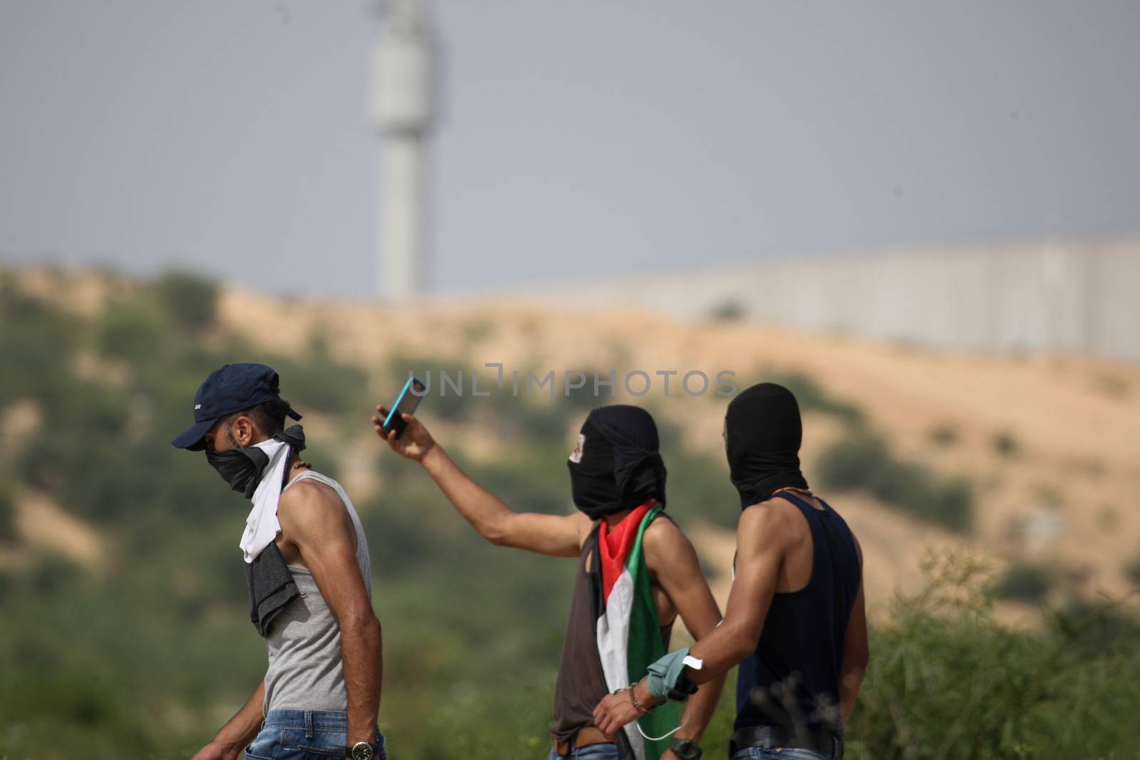 PALESTINE, Gaza Strip: Three young men walk near the Erez crossing between Israel and the Gaza Strip as protesters battled with Israeli security forces on October 13, 2015.As a wave of stabbings hit Jerusalem, violent protests flared up in the West Bank. The unrest has lead to warnings that a full-scale Palestinian uprising, or Intifada, could erupt. The unrest has also spread to the Gaza Strip, with fighting along the border in recent days leaving nine Palestinians dead. 
