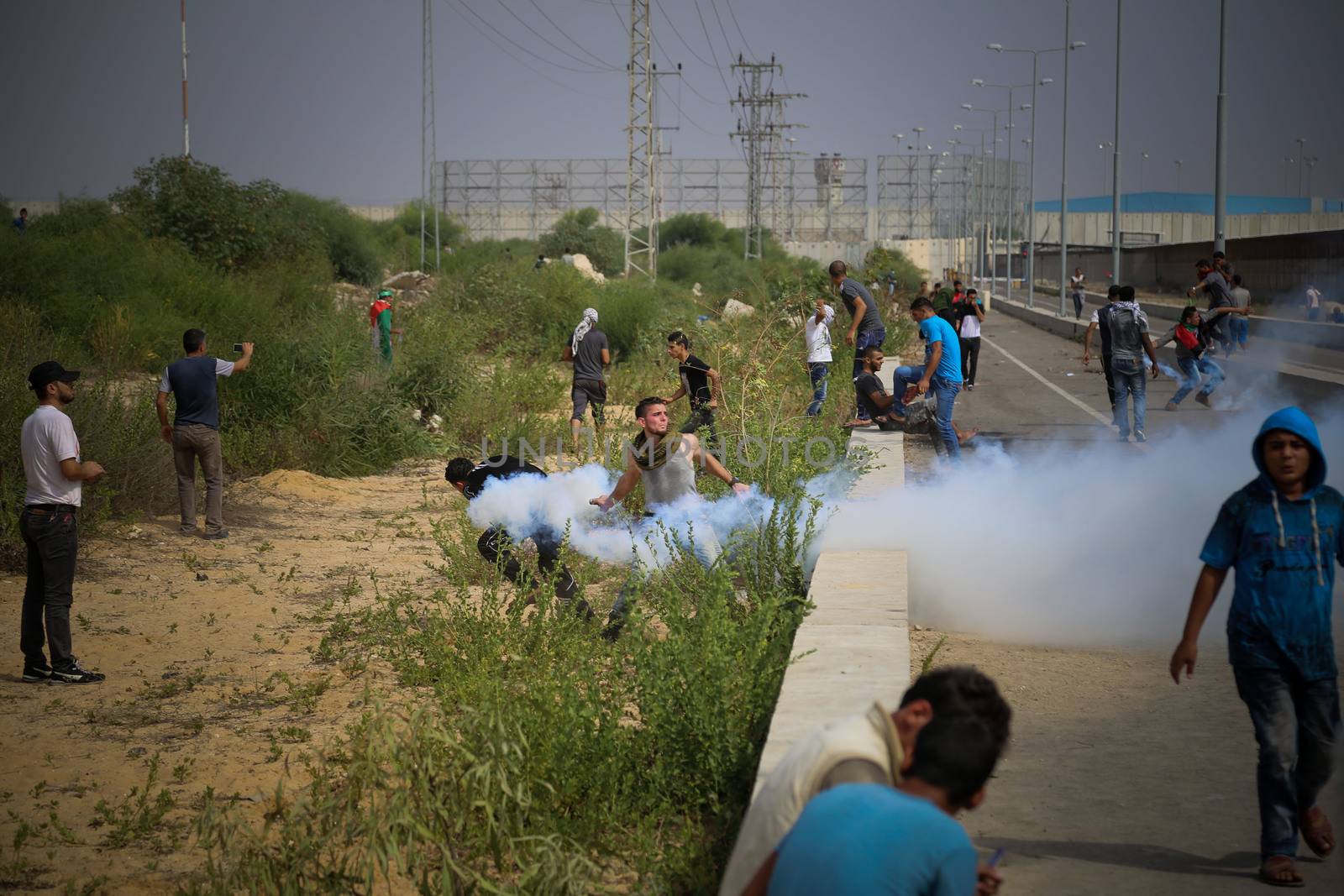 PALESTINE, Gaza Strip: A Palestinian protesters throws a can of tear gas near the Erez crossing between Israel and the Gaza Strip as protesters battled with Israeli security forces on October 13, 2015.As a wave of stabbings hit Jerusalem, violent protests flared up in the West Bank. The unrest has lead to warnings that a full-scale Palestinian uprising, or Intifada, could erupt. The unrest has also spread to the Gaza Strip, with fighting along the border in recent days leaving nine Palestinians dead. 