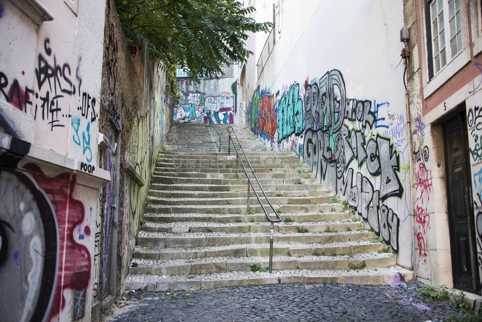 LISBON, PORTUGAL - SEPTEMBER 26 2015: Graffit on walls near staircase in Lisbon on September 26, Lisbon is the capital of Portugal