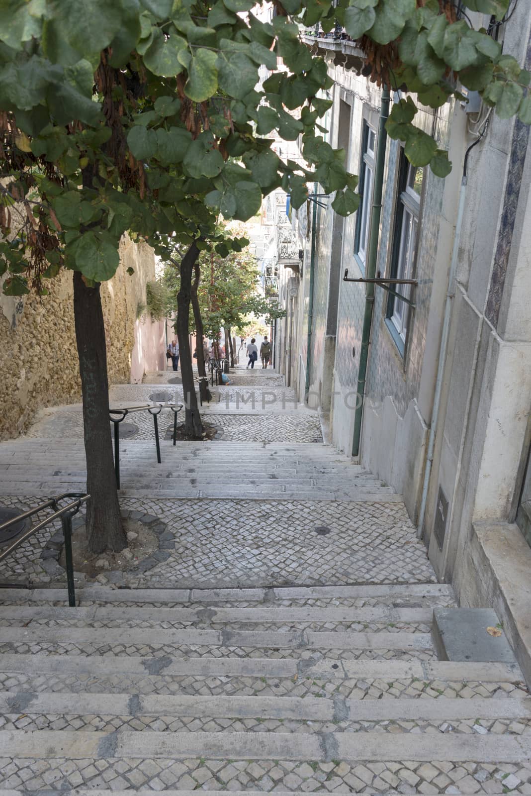 LISBON, PORTUGAL - SEPTEMBER 26: Unidentified people walking downstairs in typical small street in Lisbon in Portugal on September 26, 2015. Lisbon is a capital and must famous city of Portugal 