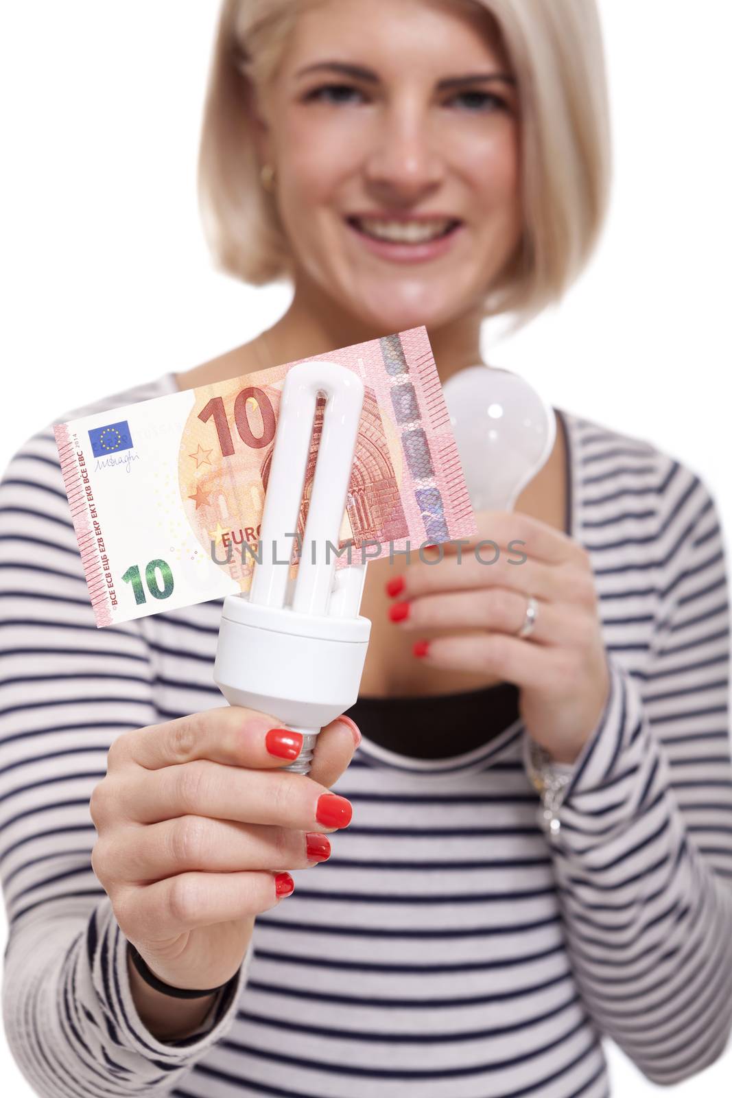 Woman holding an eco-friendly light bulb with a 10 Euro banknote threaded through it in a conceptual image of efficiency and savings