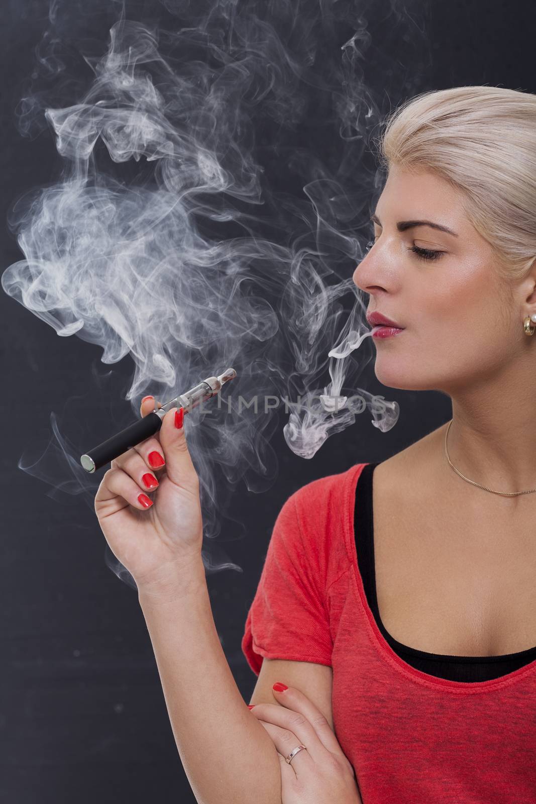 Stylish blond woman smoking an e-cigarette by juniart