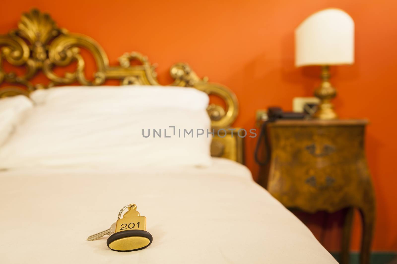 Hotel Room Key lying on Bed with keyring golden