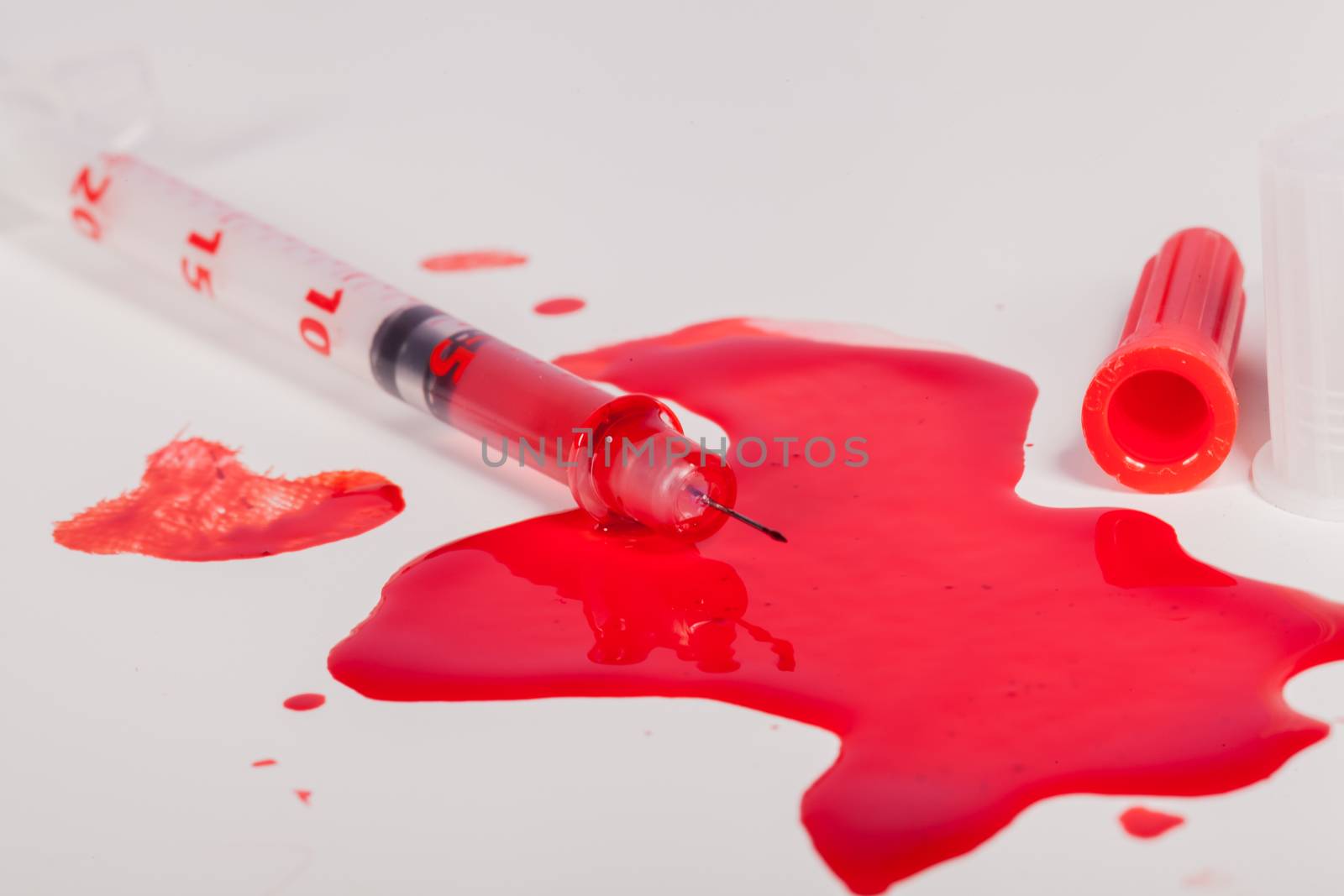 Syringe Squirting Red Blood onto White Background by juniart