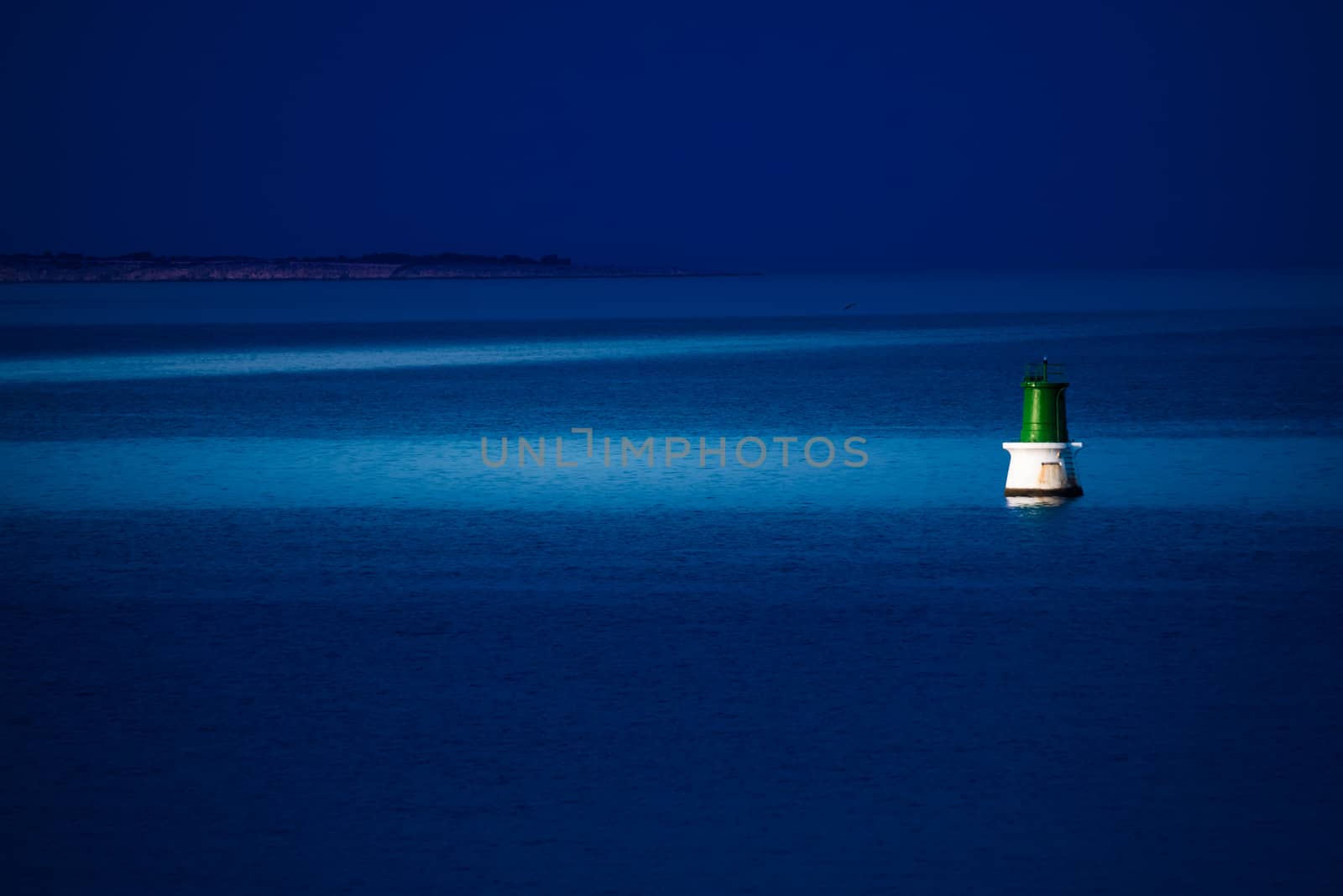 A buoy is reached at night by a patrol boat to be repaired.