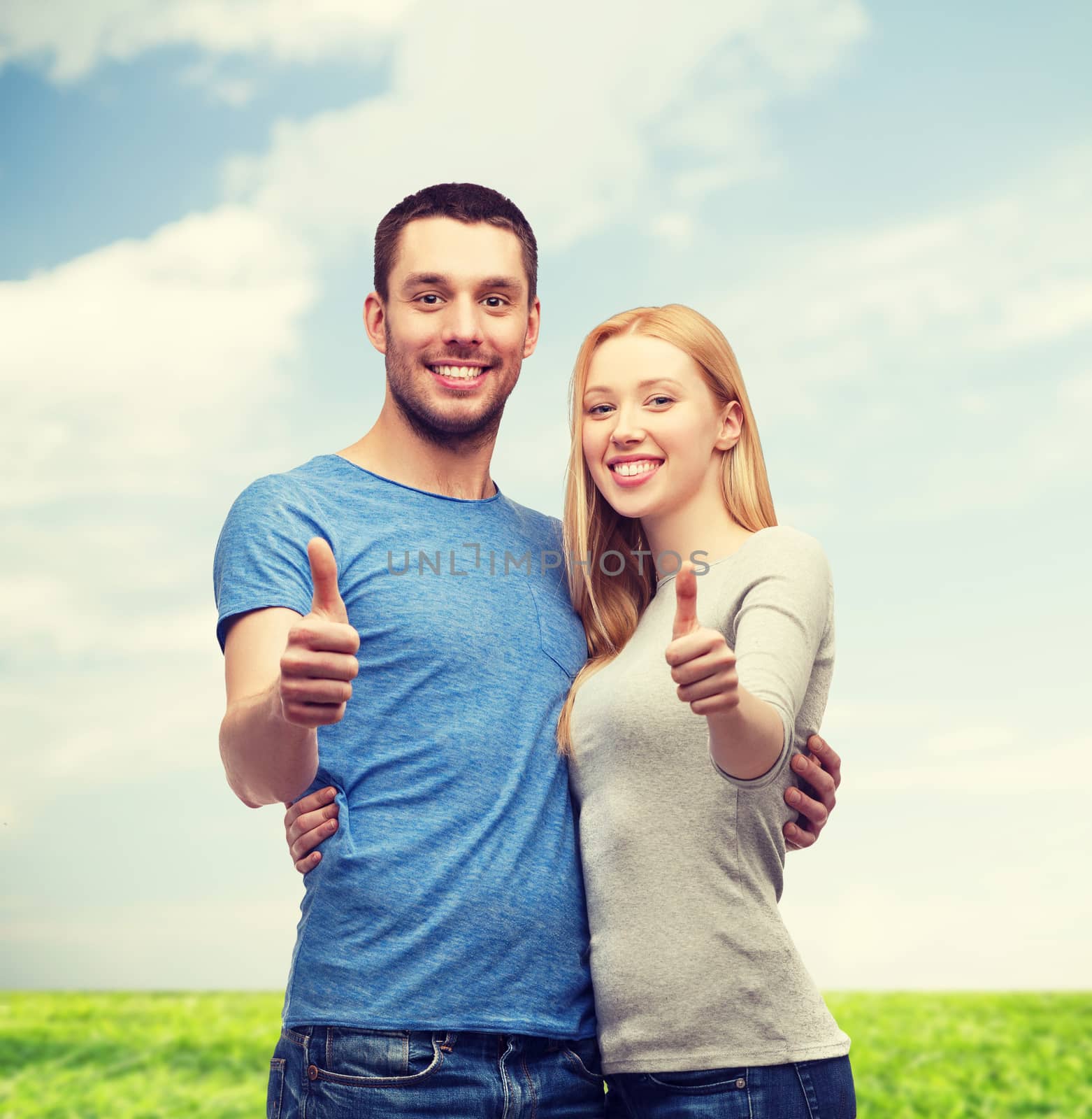 couple, gesture and family concept - smiling couple showing thumbs up