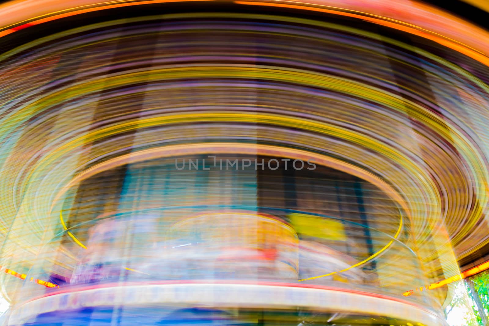 Motion blurr of vintage merry-go-round carousel.