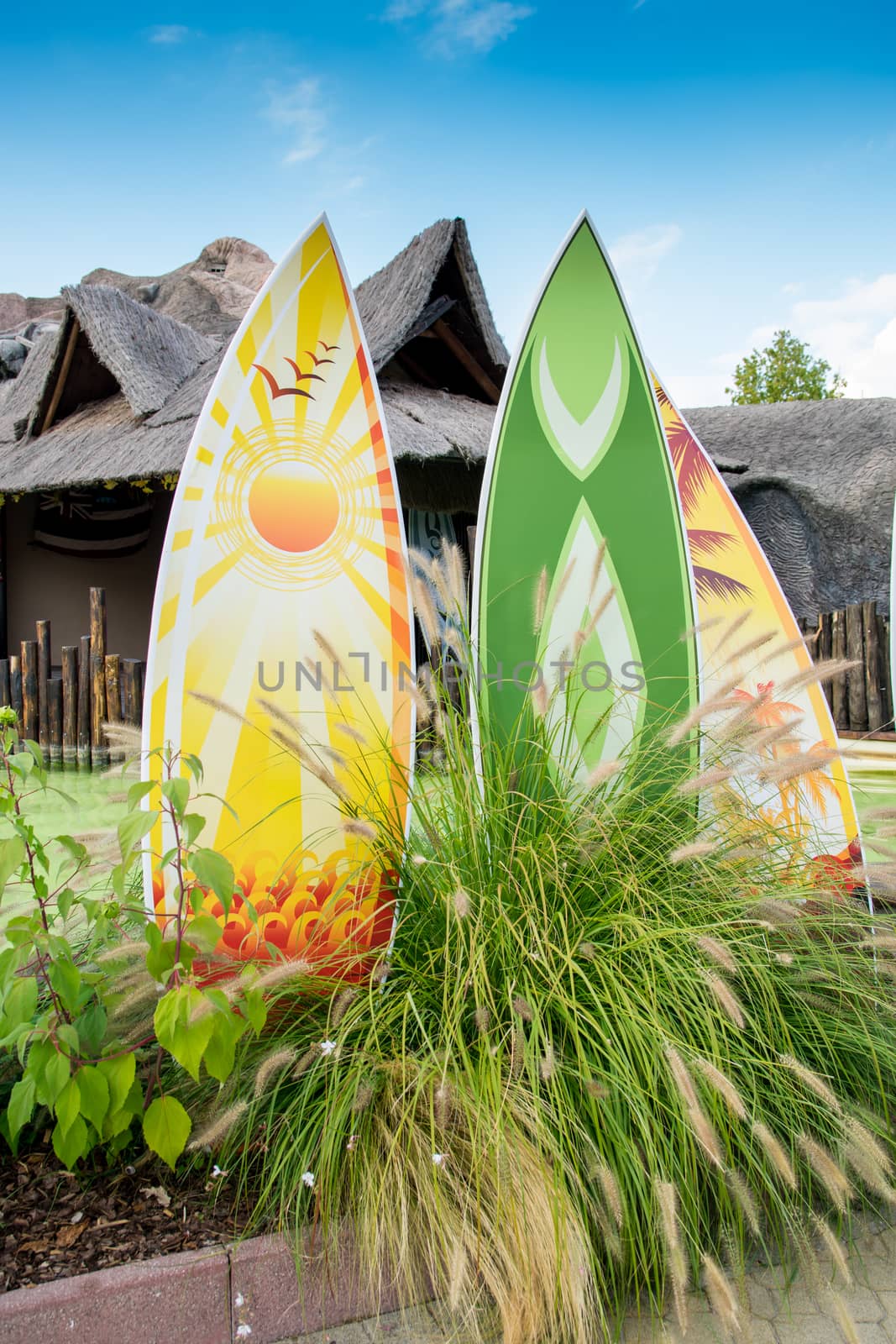 HONOLULU, HAWAII - MAY 9: Colorful surfboards in front of a typical Hawaiian hut.