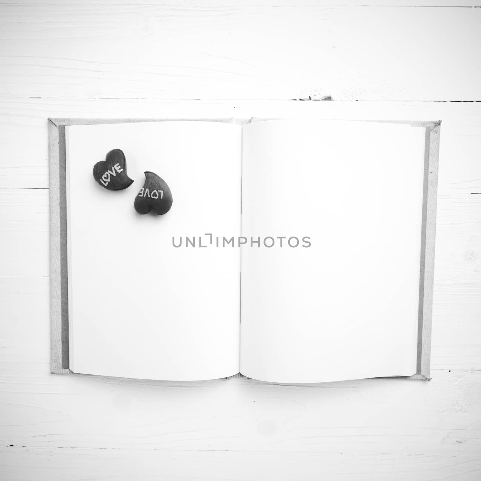 heart on notebook over white table black and white tone color style