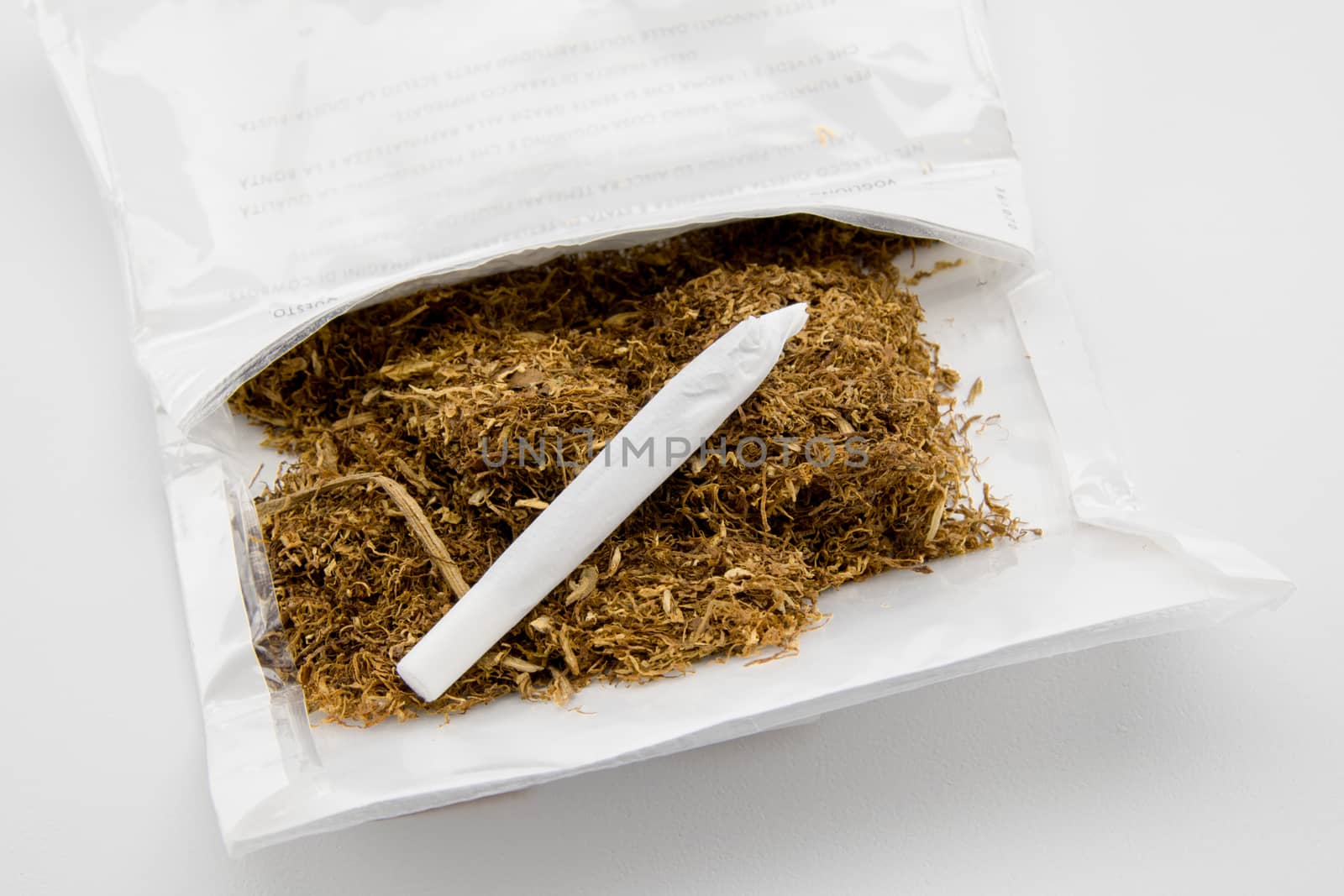 package of tobacco and hand made cigarette