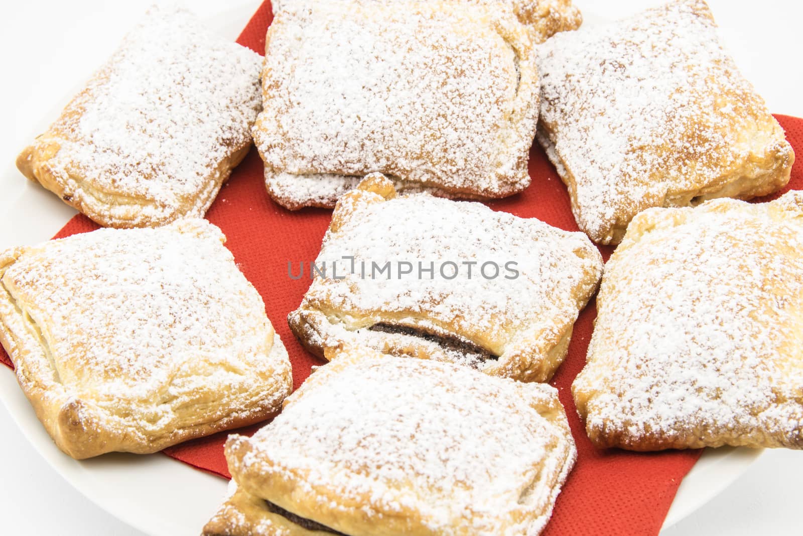 handmade biscuits of puff pastry stuffed with chocolate and covered with powdered sugar