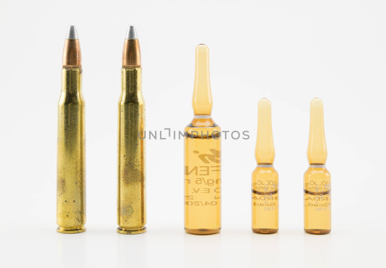 composition with vials and bullets on white background