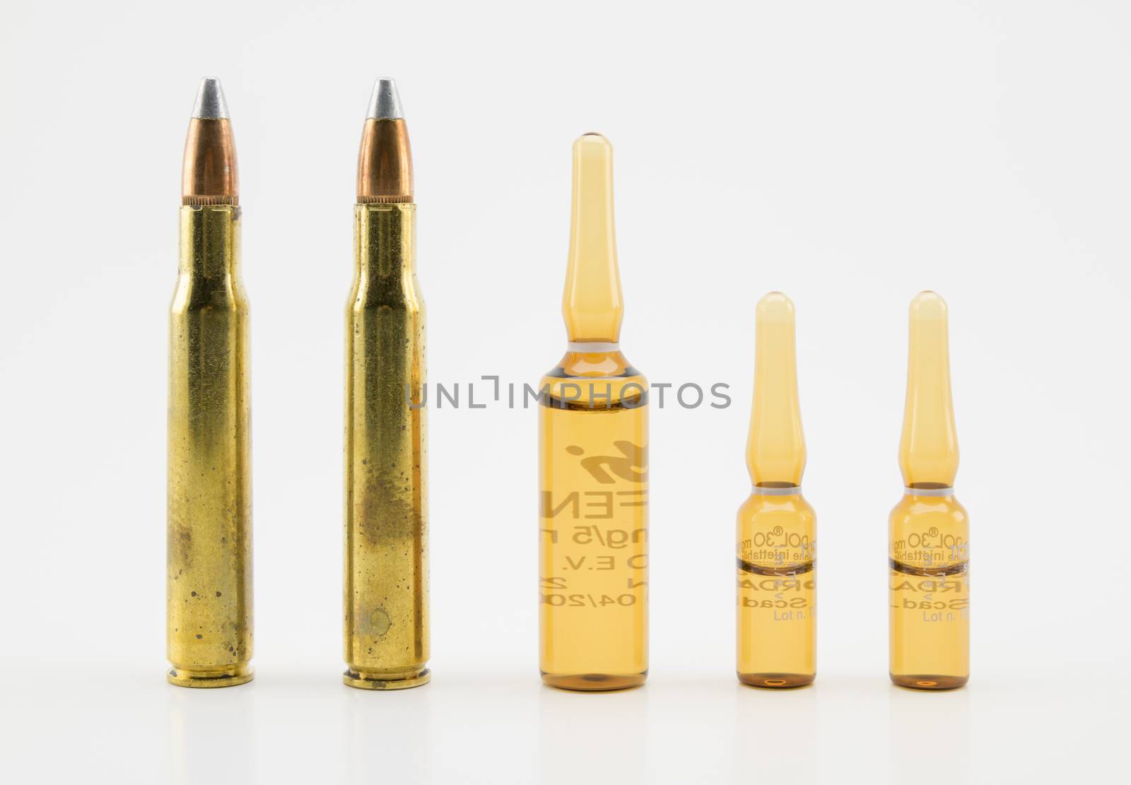 composition with vials and bullets on white background