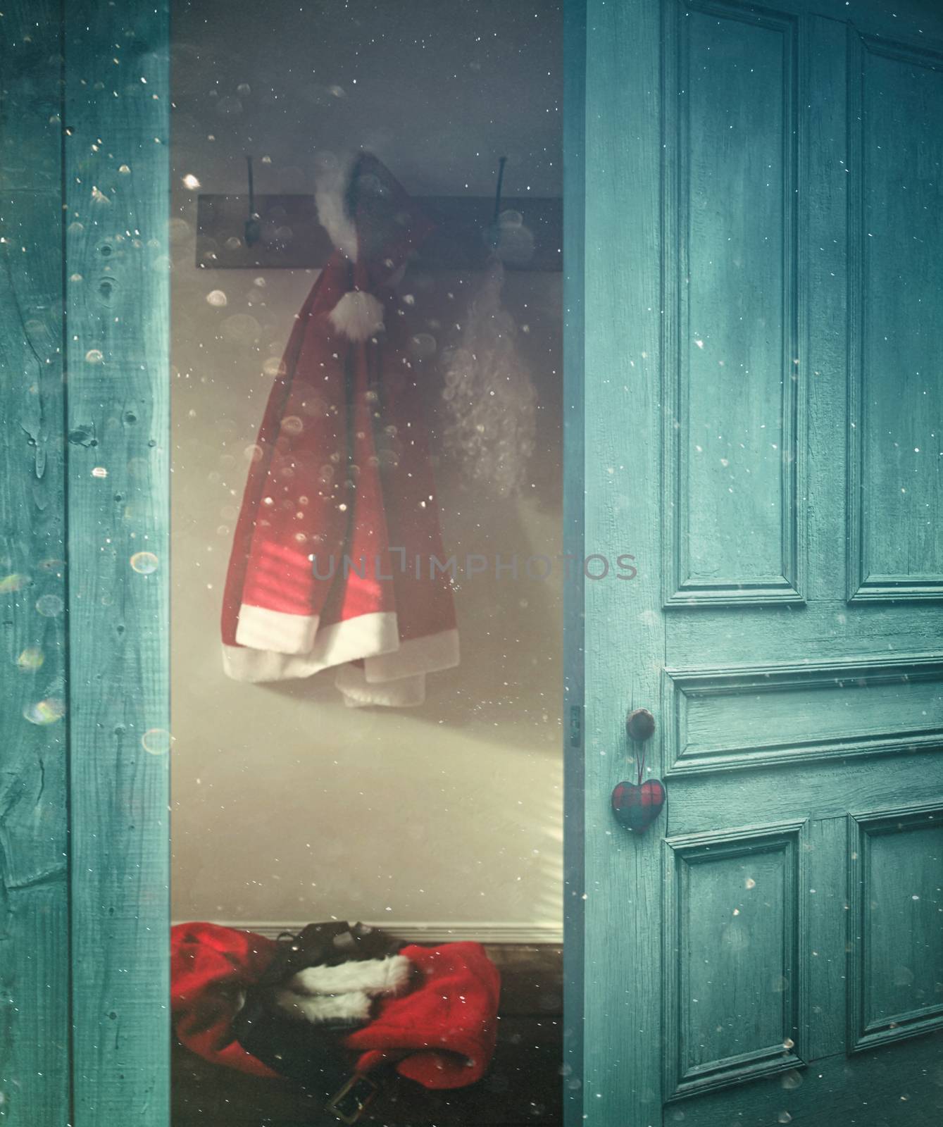 Rustic door opening into a room decorated for Christmas 