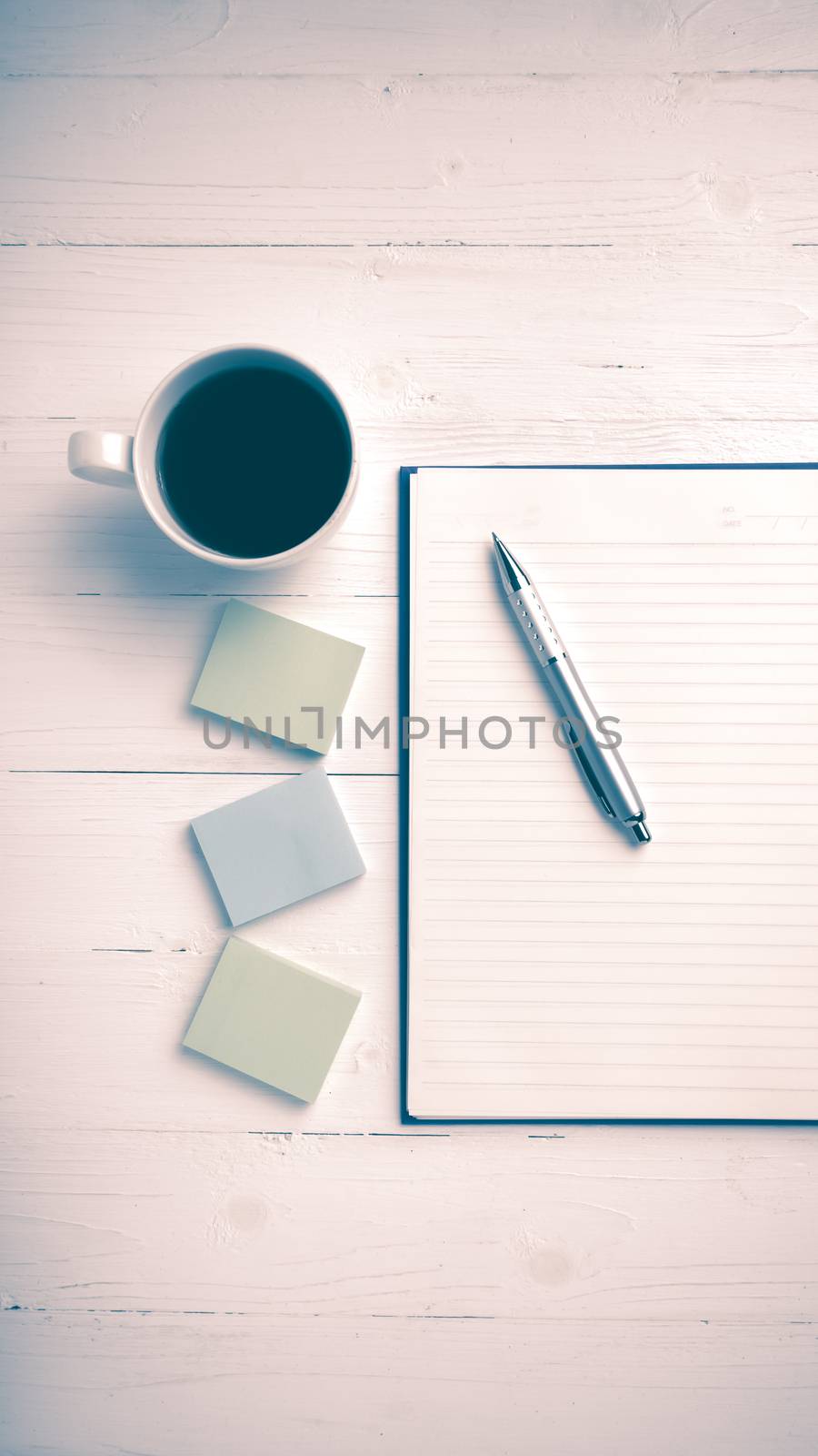 notepad and coffee cup on white table view from above vintage style