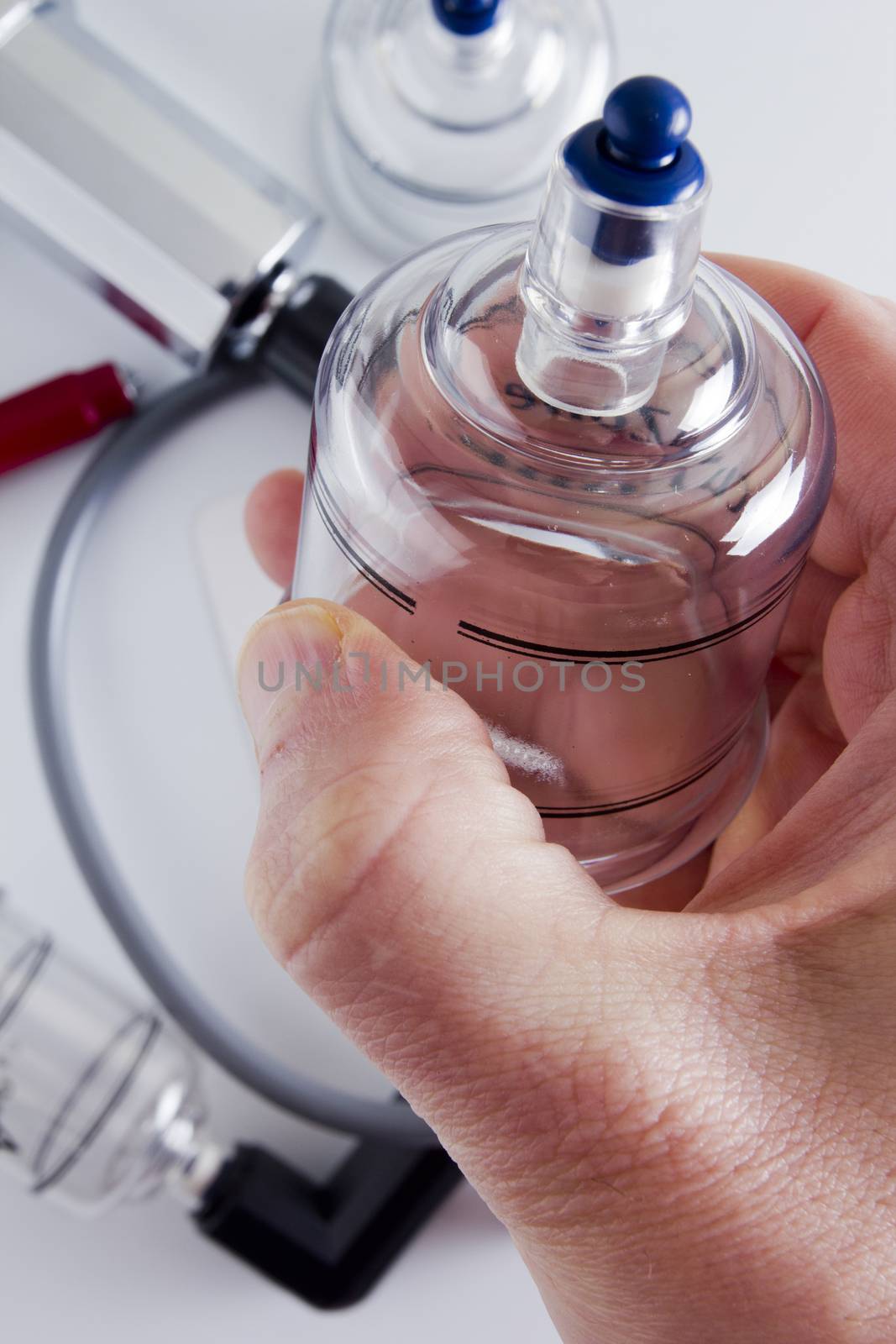 Tools for vacuum massage in a man's hand.