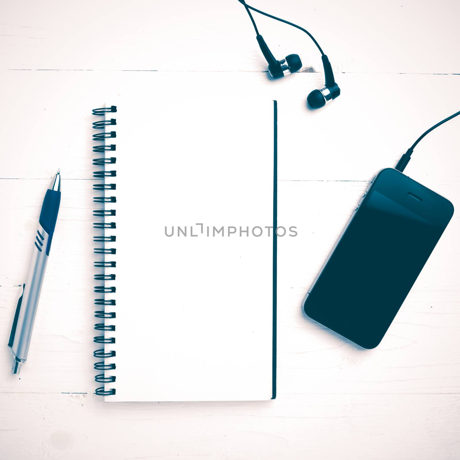 notepad and cellphone over white table vintage style