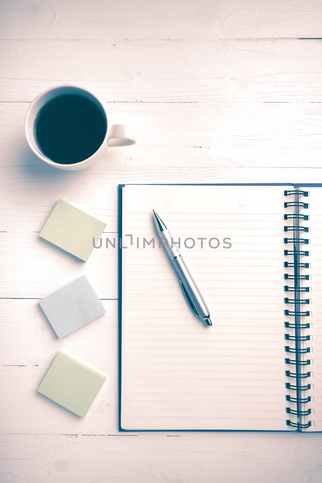 notepad and coffee cup on white table view from above vintage style