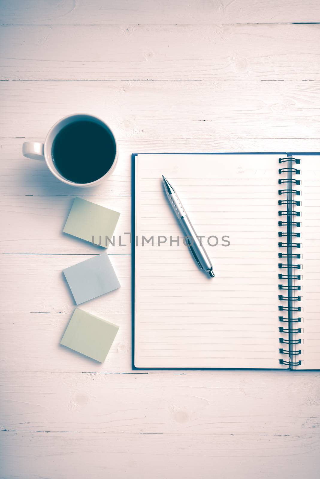 notepad and coffee cup on white table view from above vintage style