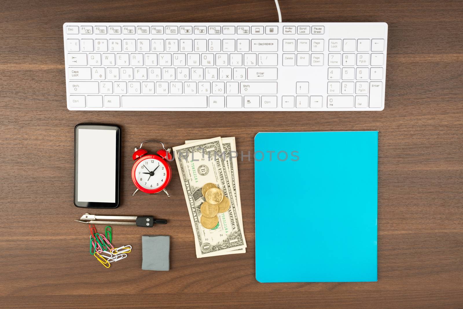 Cash with office supplies on wooden table