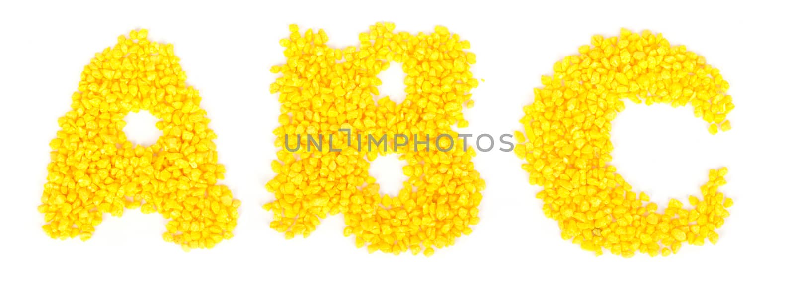 Alphabet gravel on isolated white background, close up view