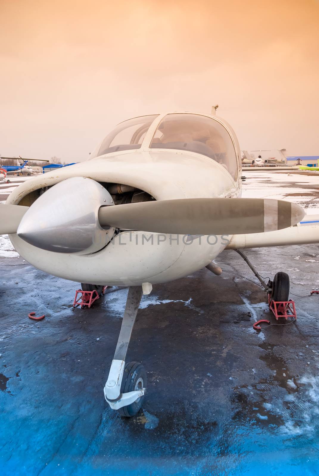 a private plane is at the airport at non-flying weather, winter