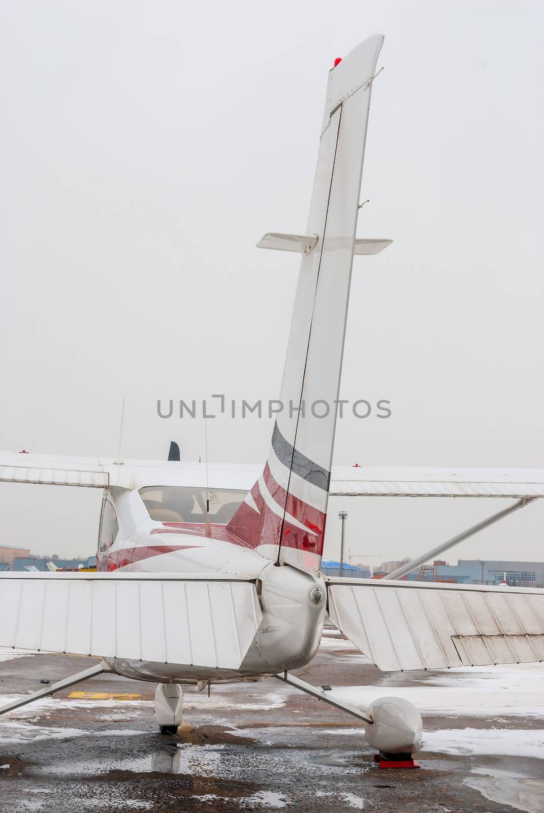 private plane at the airport is photographed close-up rear by kosmsos111