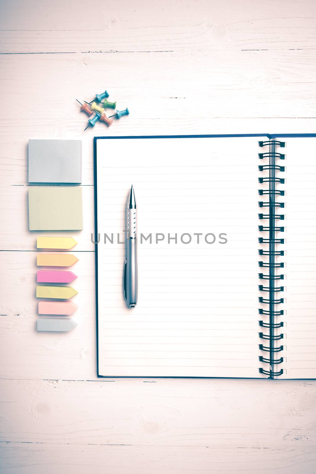 notepad with office supplies on white table view from above vintage style