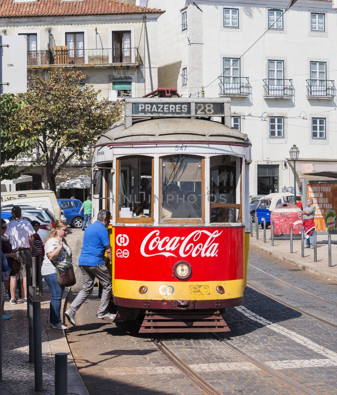 LISBON, PORTUGAL - SEPTEMBER 26: Unidentified people getting on the Yellow tram  goes by the street of Lisbon city center on September 26, 2015. Lisbon is a capital and must famous city of Portugal