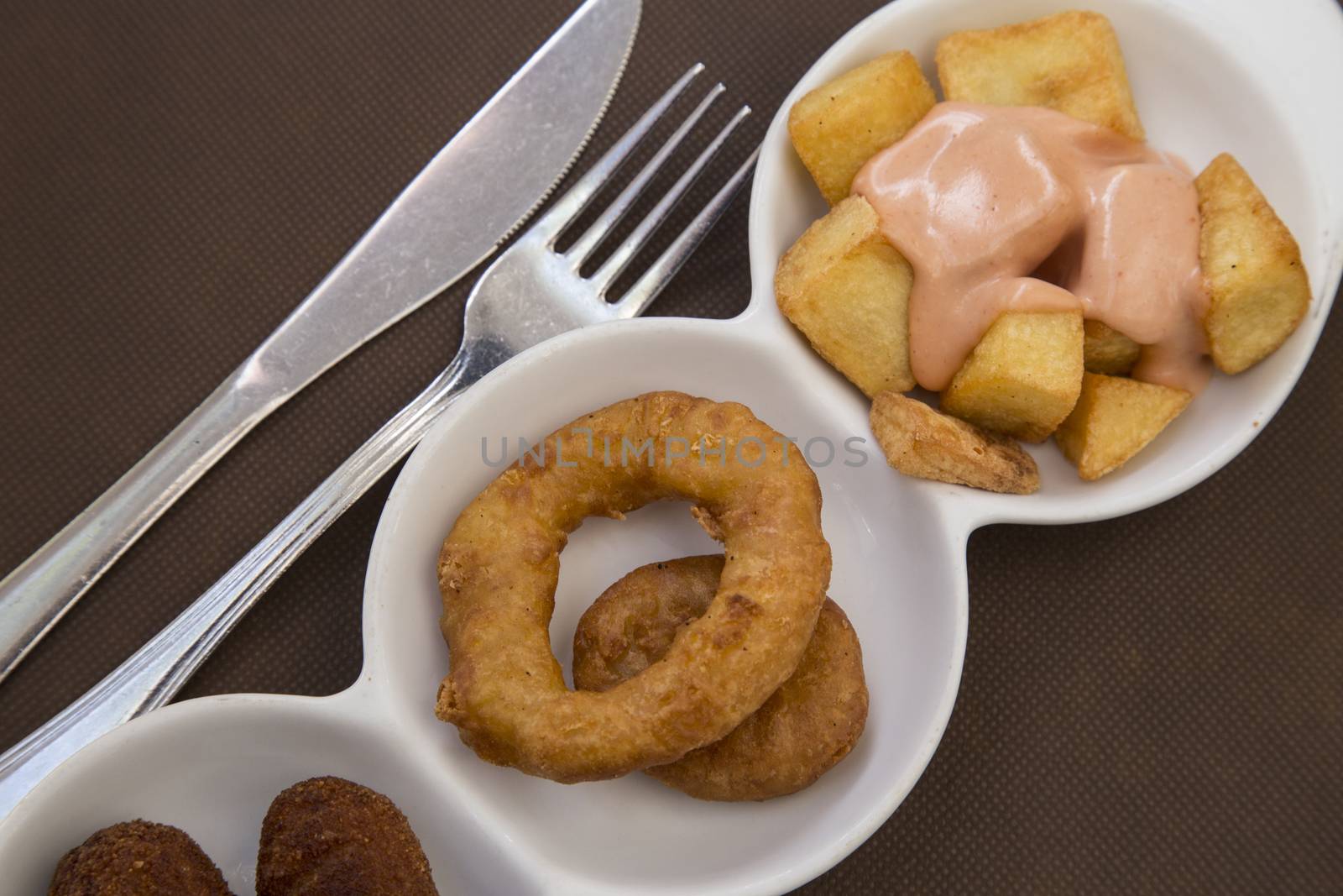 Spanish tapas fried squid rings and potates braves