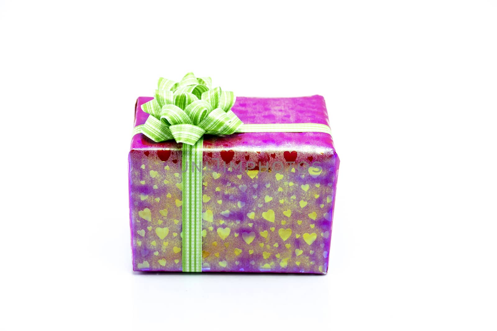 pink gift box with green ribbon bow by teerawit