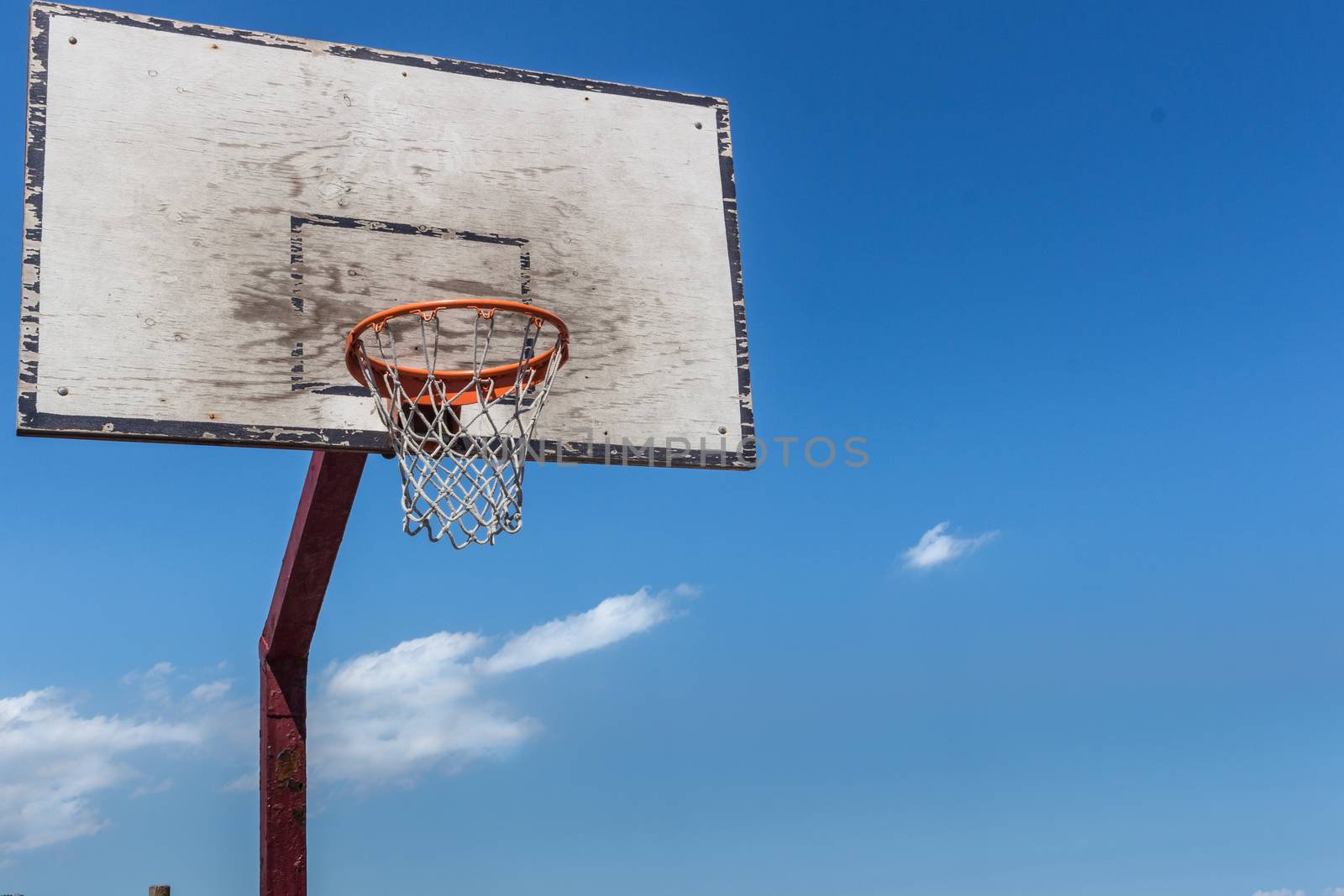 Baskeball hoop on a sunny day.