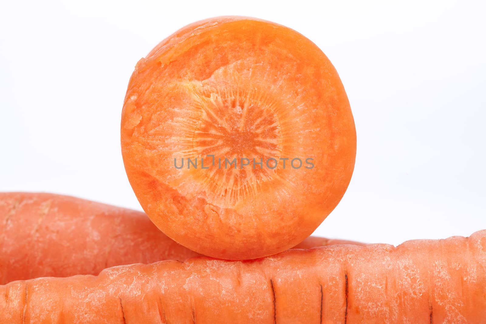 cut carrot on white background, close up.